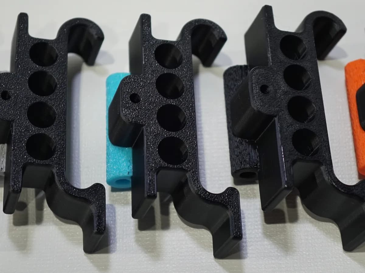 A row of printed grill clips in several filament colours